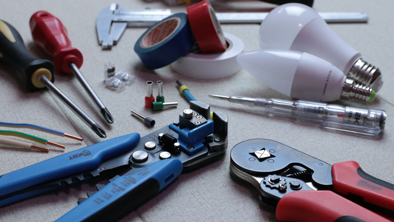 A variety of electrical tools sitting on a flat surface