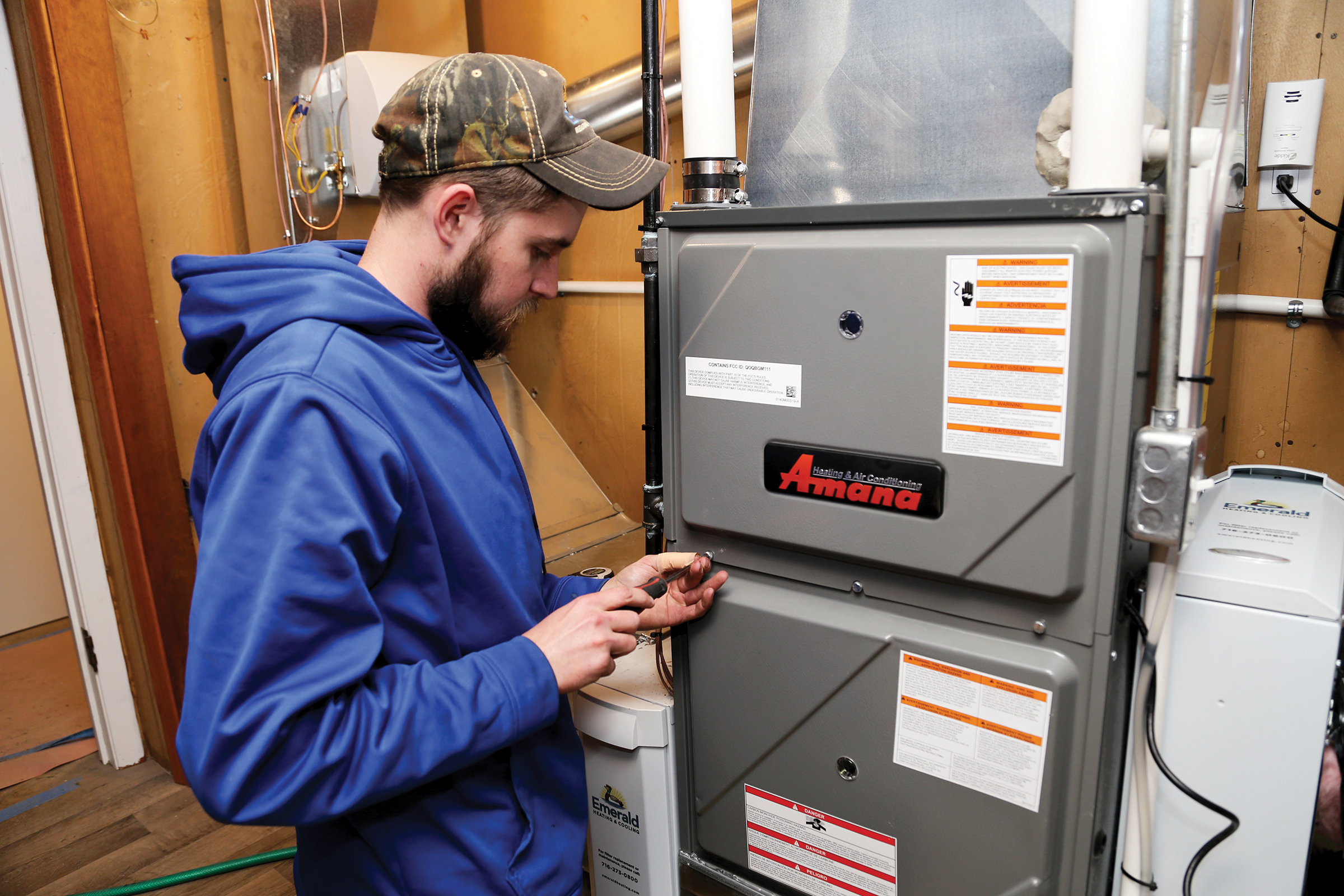 hvac technician inspecting furnace