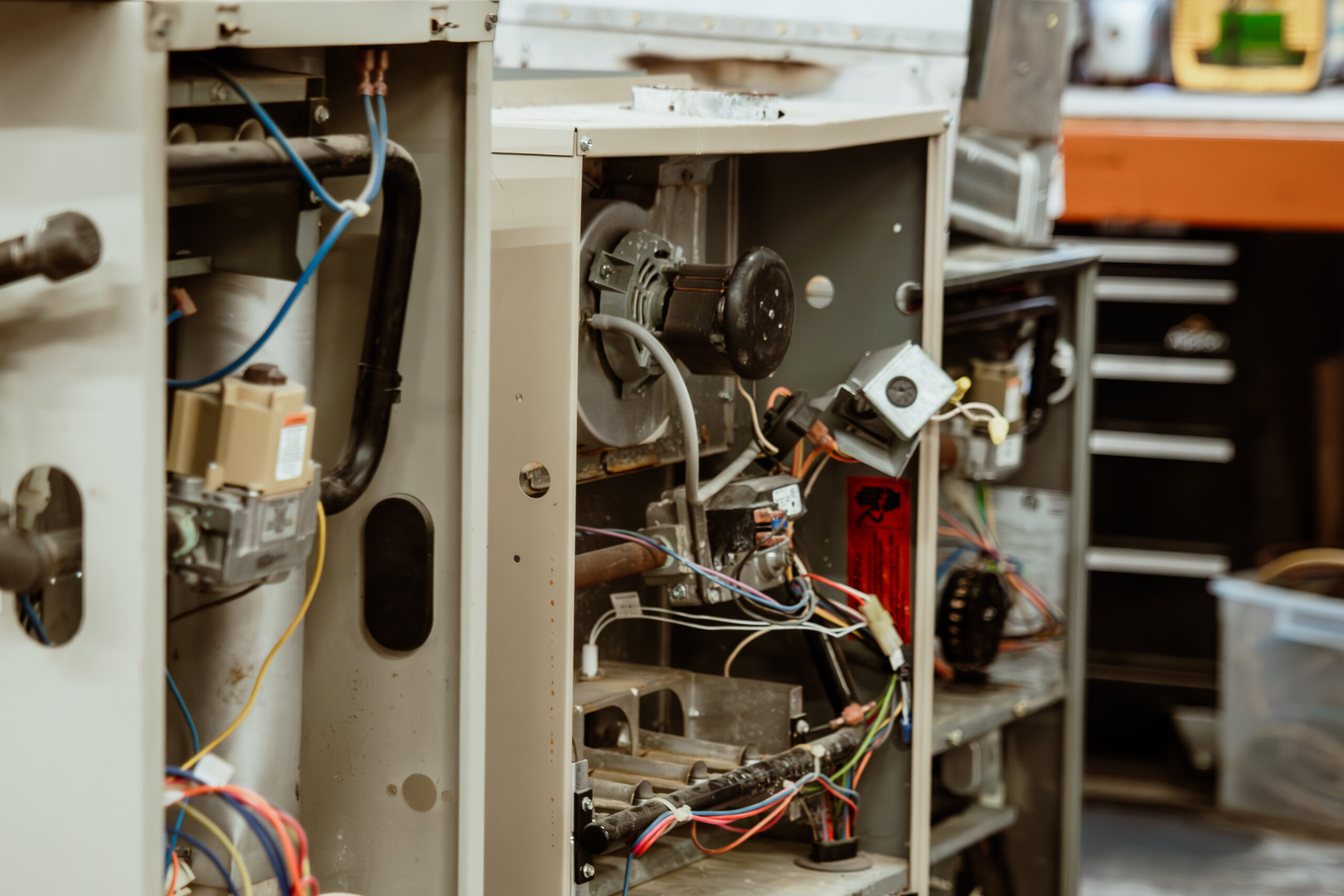 Open furnaces lined in a row, ready for maintenance. Wires and parts are visible.