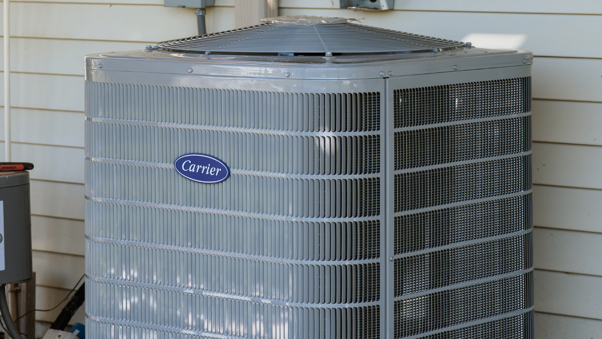 Condenser air conditioning unit outside of house 