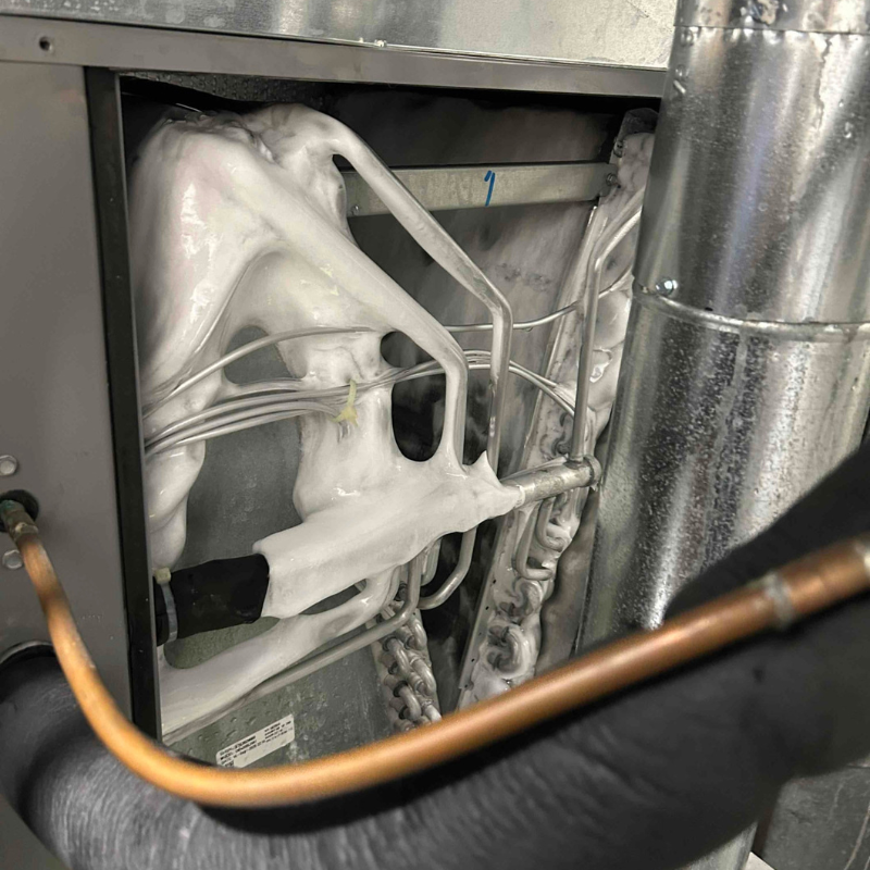 Close up image of ice formation on the indoor evaporator coil. This is likely an indicator of a leak or low refrigerant. 
